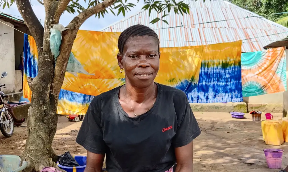 Isatu improved her tie-dying business with a loan from Kwanda.